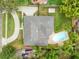 Aerial view of the property featuring a pool, landscaping, and driveway at 922 Puma Trl, Winter Springs, FL 32708