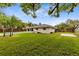 Expansive backyard featuring a pool, lush lawn, and privacy fence at 922 Puma Trl, Winter Springs, FL 32708