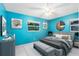 Bright bedroom with blue walls, ceiling fan, neutral decor, and natural light at 922 Puma Trl, Winter Springs, FL 32708