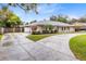 Charming single-story home with a large driveway and manicured landscaping at 922 Puma Trl, Winter Springs, FL 32708