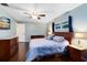 Relaxing main bedroom features wood floors, cool paint color, and a ceiling fan at 922 Puma Trl, Winter Springs, FL 32708