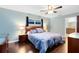 Comfortable main bedroom with wood floors and a view to the ensuite bathroom at 922 Puma Trl, Winter Springs, FL 32708