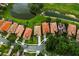 Aerial view of well-maintained homes with red tile roofs and manicured landscaping at 9235 San Jose Blvd, Howey In The Hills, FL 34737