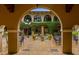 Beautiful courtyard featuring a fountain, seating, and lush greenery at 9235 San Jose Blvd, Howey In The Hills, FL 34737