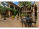 Charming courtyard featuring tables, fountain, greenery, and unique architecture at 9235 San Jose Blvd, Howey In The Hills, FL 34737