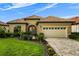Attractive home with a tile roof, two-car garage and well-manicured lawn and landscaping at 9235 San Jose Blvd, Howey In The Hills, FL 34737