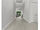 Inviting hallway featuring neutral paint, trim, and flooring leading to living area at 9235 San Jose Blvd, Howey In The Hills, FL 34737