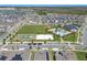 Aerial view of community amenities featuring a pool, playground, and sports facilities amid neighborhood homes at 9834 Introduction Way, Orlando, FL 32832