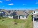 Aerial view of backyard and houses with solar panels on a sunny day at 9834 Introduction Way, Orlando, FL 32832