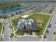 Overhead view of community amenities including swimming pool, clubhouse, beach volleyball court, and playground at 9834 Introduction Way, Orlando, FL 32832