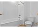 Bright bathroom features a white shower-tub combination and standard toilet at 9834 Introduction Way, Orlando, FL 32832