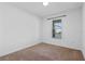 Cozy bedroom featuring neutral carpet and a single, well-lit window at 9834 Introduction Way, Orlando, FL 32832