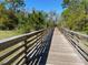 Picture of a beautiful wooden boardwalk meandering through a verdant, natural landscape at 9834 Introduction Way, Orlando, FL 32832