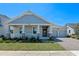 Beautiful single-story home boasts a covered front porch and a convenient two-car garage at 9834 Introduction Way, Orlando, FL 32832