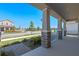 Relaxing covered front porch with brick-accented columns overlooking a well-manicured lawn and a peaceful street at 9834 Introduction Way, Orlando, FL 32832