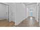 Inviting hallway with wood-look tile flooring, bright white walls, and modern recessed lighting at 9834 Introduction Way, Orlando, FL 32832