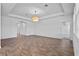 Bright living room features wood-look tile floors, a tray ceiling and modern lighting at 9834 Introduction Way, Orlando, FL 32832