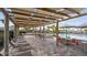 Leisurely poolside seating area featuring lounge chairs and tables under a shaded pergola, perfect for relaxation at 9834 Introduction Way, Orlando, FL 32832