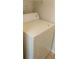 Dryer machine within the condo, featuring storage shelves above it at 1029 S Hiawassee Rd # 2414, Orlando, FL 32835