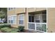 Tan condo exterior with a small balcony, white trim, and green landscaping at 1029 S Hiawassee Rd # 2414, Orlando, FL 32835