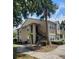 Tan two-story condo with exterior stairs, a palm tree, and a sidewalk at 1029 S Hiawassee Rd # 2414, Orlando, FL 32835