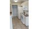 Well-lit kitchen featuring white appliances and tile floors and plenty of storage at 1029 S Hiawassee Rd # 2414, Orlando, FL 32835