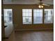 A bright living room with lots of natural light from three windows and a ceiling fan at 1029 S Hiawassee Rd # 2414, Orlando, FL 32835