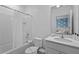Bright bathroom featuring a tub shower, a toilet, and a vanity with a large mirror and clean design at 10364 Ebb Tide Ln, Orlando, FL 32821