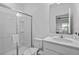 Well-lit bathroom featuring a glass-enclosed shower and modern vanity with a clean design at 10364 Ebb Tide Ln, Orlando, FL 32821