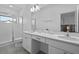 Bathroom featuring a shower, double sink vanity, and commode at 10364 Ebb Tide Ln, Orlando, FL 32821
