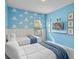 Vibrant bedroom with 'Toy Story' theme, cloud accents, and two cozy beds at 10364 Ebb Tide Ln, Orlando, FL 32821