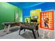 Vibrant game room with ping pong and foosball ready for friendly competition at 10364 Ebb Tide Ln, Orlando, FL 32821