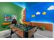 Brightly lit game room with custom murals and a foosball table at 10364 Ebb Tide Ln, Orlando, FL 32821