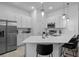 Bright kitchen features stainless steel appliances, quartz countertops, and bar seating, perfect for modern living at 10364 Ebb Tide Ln, Orlando, FL 32821