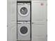 Space-saving laundry area with stacked washer and dryer units inside a closet at 10364 Ebb Tide Ln, Orlando, FL 32821