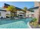 Resort-style pool with palm trees, lounge chairs, and waterfall feature at 10364 Ebb Tide Ln, Orlando, FL 32821