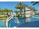 Resort-style pool with chair lift, waterfall feature, palm trees and blue skies at 10364 Ebb Tide Ln, Orlando, FL 32821