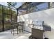 An outdoor kitchen area with a grill and barstool seating at 10364 Ebb Tide Ln, Orlando, FL 32821