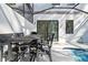 A pool side seating area outside with an outdoor dining table at 10364 Ebb Tide Ln, Orlando, FL 32821