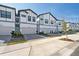 Street-level view of modern townhomes showing individual driveways with paver accents and well-maintained landscaping at 10364 Ebb Tide Ln, Orlando, FL 32821