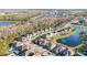 Panoramic aerial of community with lake view, lush landscaping, and beautiful homes at 11464 Beau Repost Dr, Orlando, FL 32832