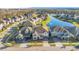 Aerial view showcasing a lakeside community with neatly manicured lawns, mature trees, and well-maintained homes at 11464 Beau Repost Dr, Orlando, FL 32832