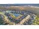 An aerial view of a neighborhood featuring a community lake at 11464 Beau Repost Dr, Orlando, FL 32832
