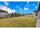 Large backyard with a black metal fence with neighborhood view and plentiful trees at 11464 Beau Repost Dr, Orlando, FL 32832