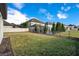 Beautifully landscaped backyard with green grass and a black metal fence surrounding a refreshing swimming pool at 11464 Beau Repost Dr, Orlando, FL 32832