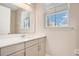 Bright bathroom featuring a single vanity, quartz countertop, and a window at 11464 Beau Repost Dr, Orlando, FL 32832
