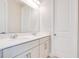 Well-lit bathroom features double vanity, quartz countertop, and a large mirror at 11464 Beau Repost Dr, Orlando, FL 32832