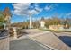 Community entrance featuring statues, landscaping, and gated entry at 11464 Beau Repost Dr, Orlando, FL 32832