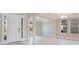 Welcoming entryway with sidelight windows, tray ceiling, and views into the spacious living area at 11464 Beau Repost Dr, Orlando, FL 32832