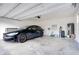 Garage featuring an electric vehicle charging station and overhead storage at 11464 Beau Repost Dr, Orlando, FL 32832